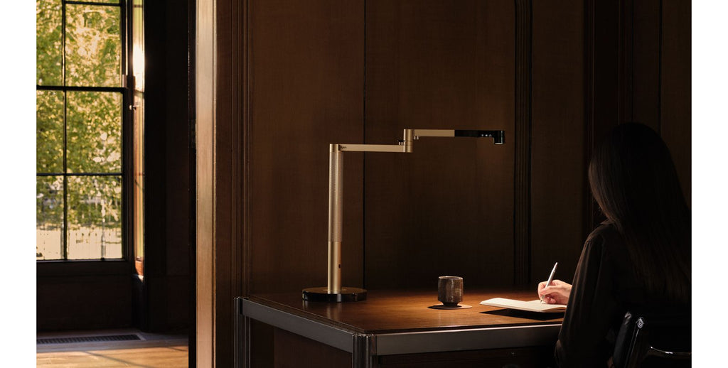 Smart LED desk lamp in daylight mode by a window