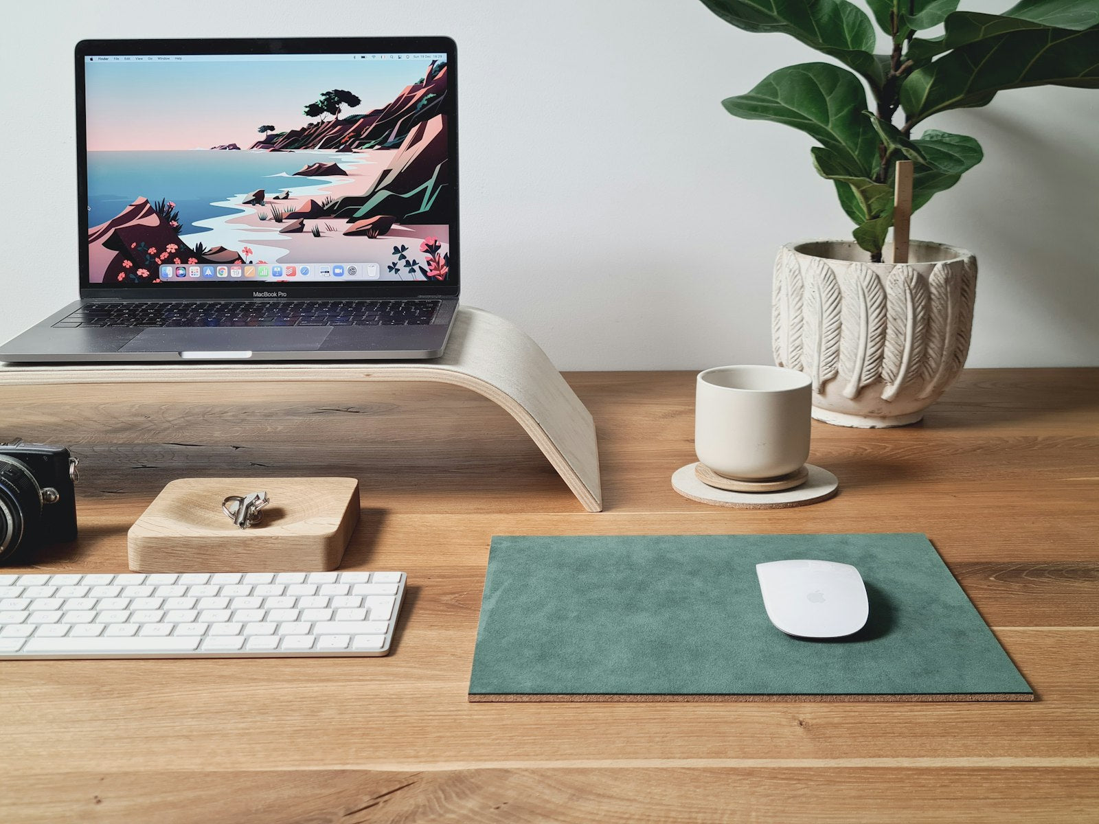 Wooden laptop stand side profile showing the curved riser