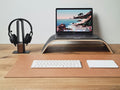 Wooden laptop stand holding a laptop, three-quarter view